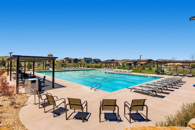 view of swimming pool featuring a patio and a pergola