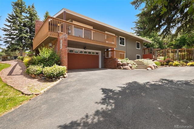 2434 Virgo Dr, Colorado Springs, CO 80906 - view of front of property with an attached garage, driveway, and a balcony