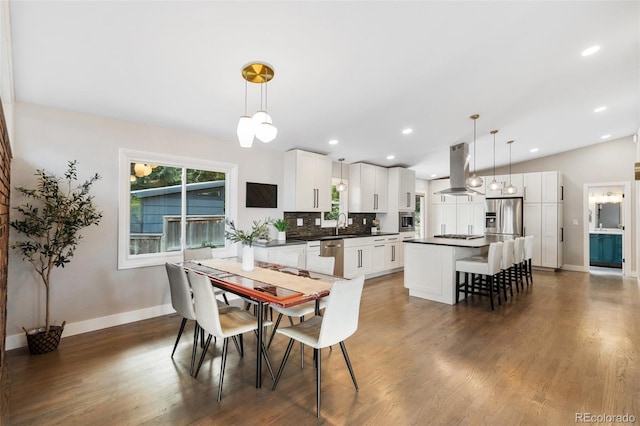 2434 Virgo Dr, Colorado Springs, CO 80906 - dining space featuring wood finished floors, recessed lighting, and lofted ceiling