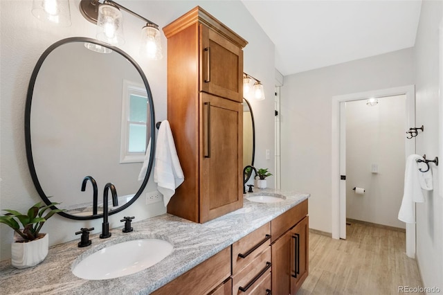 2434 Virgo Dr, Colorado Springs, CO 80906 - full bath featuring double vanity and wood finished floors
