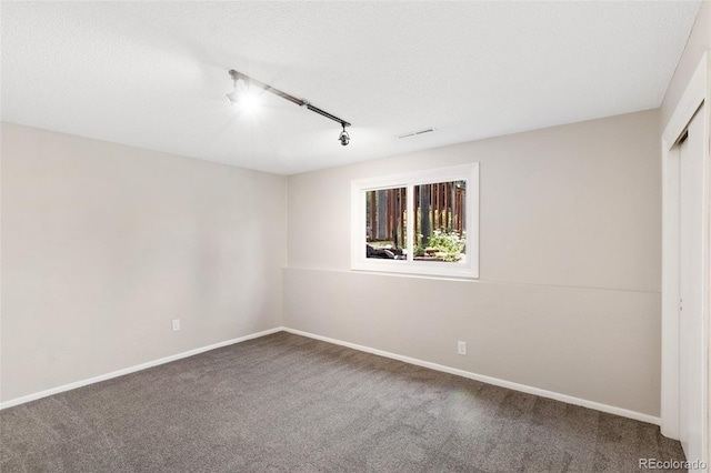 2434 Virgo Dr, Colorado Springs, CO 80906 - carpeted empty room with rail lighting and baseboards