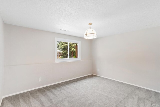 2434 Virgo Dr, Colorado Springs, CO 80906 - spare room featuring carpet floors and a textured ceiling