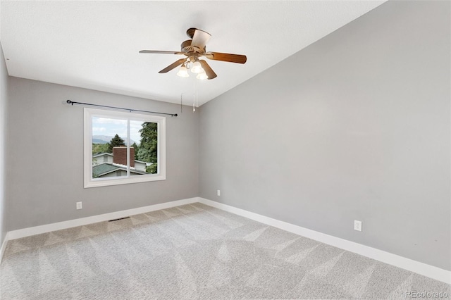 2434 Virgo Dr, Colorado Springs, CO 80906 - empty room featuring a ceiling fan, light colored carpet, and vaulted ceiling