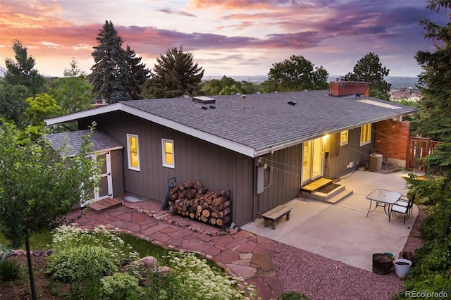 2434 Virgo Dr, Colorado Springs, CO 80906 - back of property with roof with shingles, a chimney, a patio area, and a shed