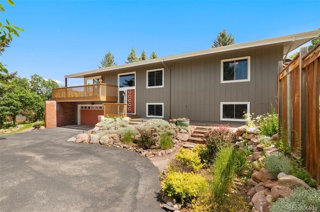 2434 Virgo Dr, Colorado Springs, CO 80906 - raised ranch featuring a balcony and asphalt driveway