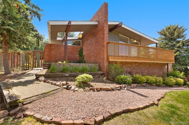 2434 Virgo Dr, Colorado Springs, CO 80906 - view of side of property with brick siding and a balcony