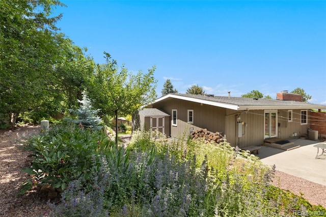 2434 Virgo Dr, Colorado Springs, CO 80906 - back of house with a patio area, a shed, and a chimney