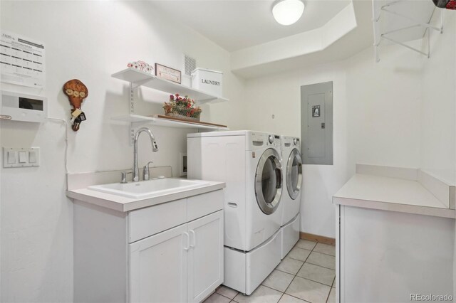 3557 Palmer Ridge Dr, Parker, CO 80134 - washroom featuring washing machine and clothes dryer, electric panel, light tile patterned floors, and cabinet space
