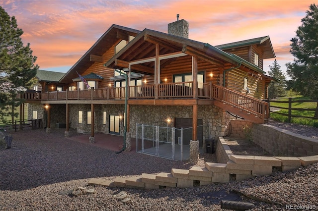3557 Palmer Ridge Dr, Parker, CO 80134 - back of property at dusk featuring a chimney, stone siding, log siding, and fence