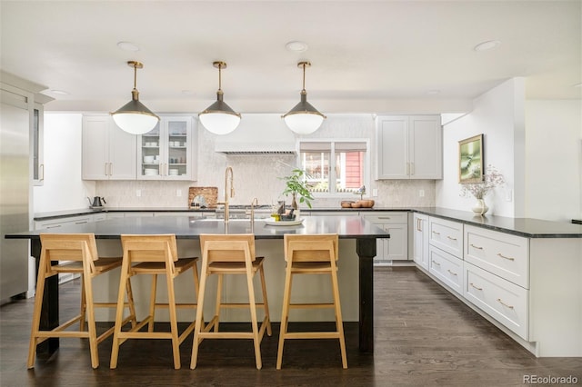 40 S Dexter St, Denver, CO 80246 - kitchen featuring backsplash, a peninsula, dark countertops, white cabinetry, and recessed lighting
