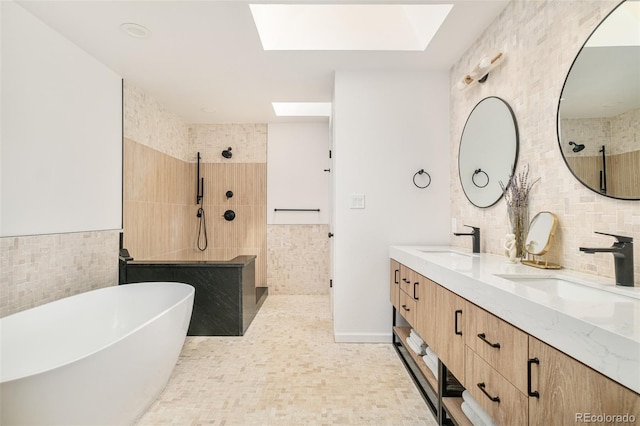 40 S Dexter St, Denver, CO 80246 - bathroom with a walk in shower, tile walls, a skylight, and double vanity