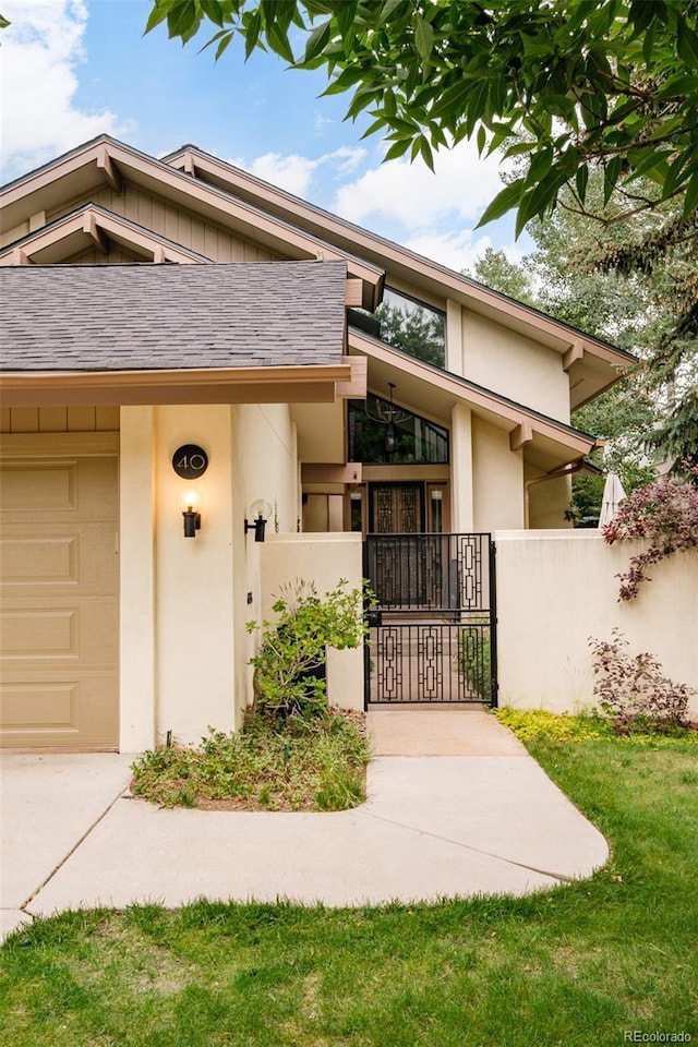 40 S Dexter St, Denver, CO 80246 - entrance to property featuring a gate, stucco siding, and driveway