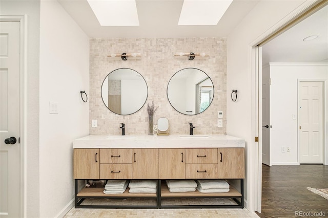 40 S Dexter St, Denver, CO 80246 - bathroom with a skylight, double vanity, wood finished floors, and backsplash