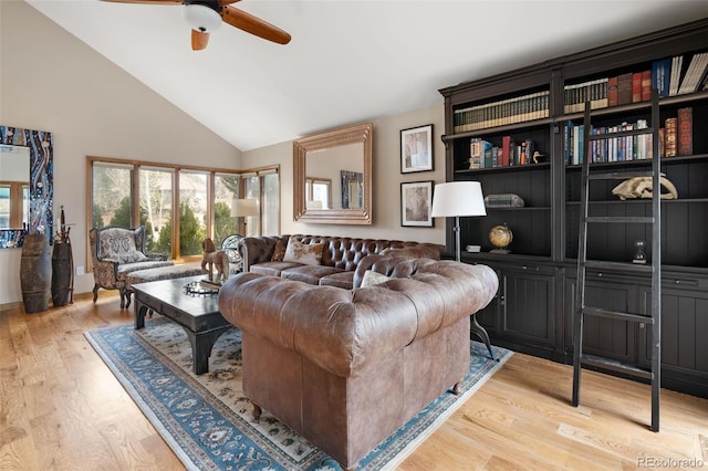 living room featuring light wood-type flooring, high vaulted ceiling, and ceiling fan