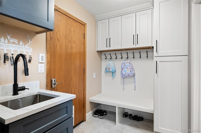 mudroom featuring a sink and light tile patterned floors