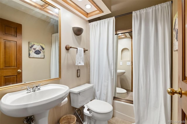 bathroom with a sink, toilet, and shower / tub combo