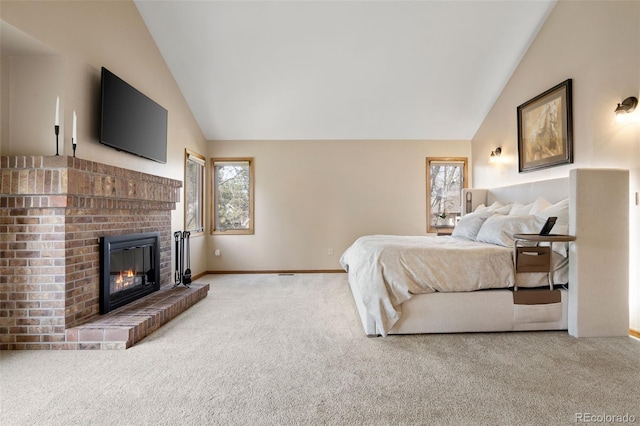 bedroom with multiple windows, carpet floors, and a brick fireplace