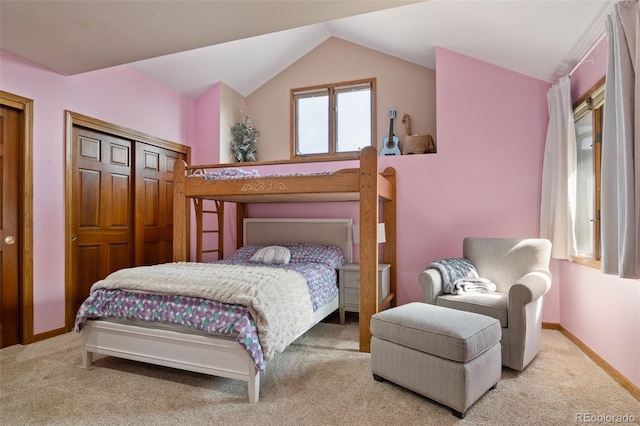 carpeted bedroom featuring baseboards and vaulted ceiling