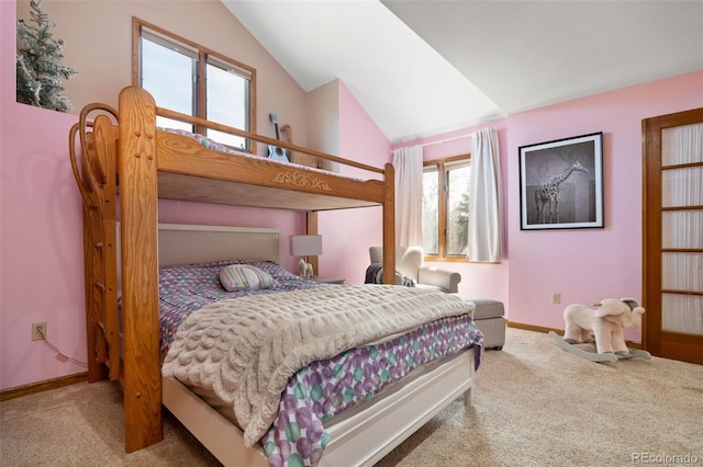 bedroom with carpet floors, baseboards, and vaulted ceiling