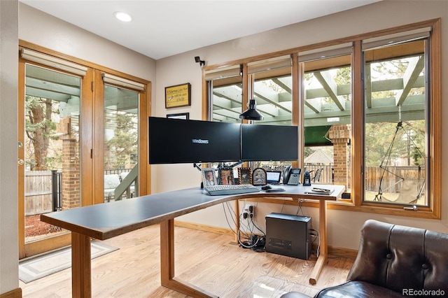 home office featuring a wealth of natural light, recessed lighting, and wood finished floors