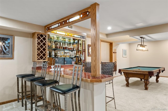 bar featuring baseboards, pool table, wet bar, and carpet