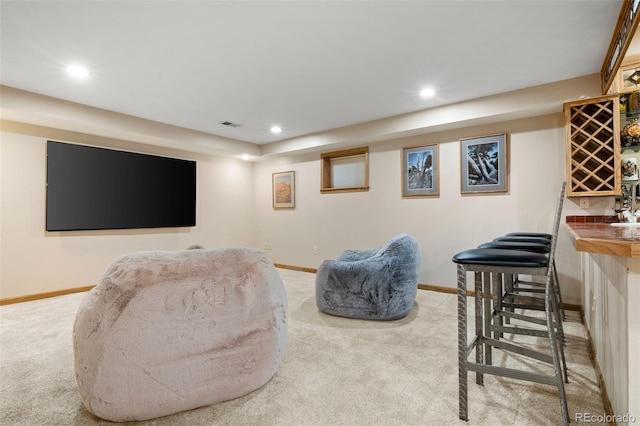 living area with carpet flooring, a dry bar, and baseboards