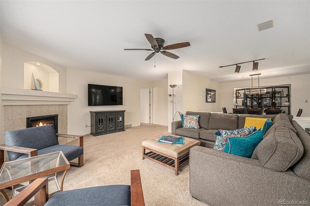 6235 W Floyd Ave, Denver, CO 80227 - carpeted living room featuring a ceiling fan, a glass covered fireplace, and rail lighting