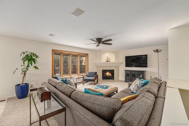 6235 W Floyd Ave, Denver, CO 80227 - living room with carpet flooring, ceiling fan, a tiled fireplace, and baseboards