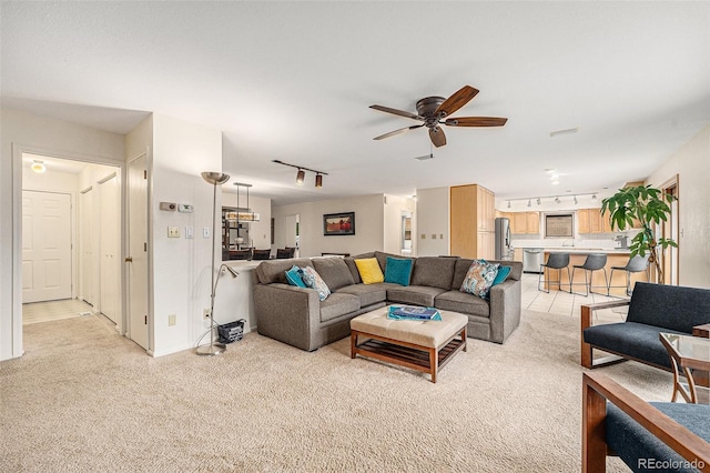 6235 W Floyd Ave, Denver, CO 80227 - living room with rail lighting, light colored carpet, a ceiling fan, and baseboards
