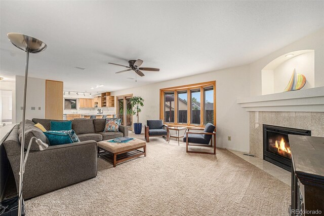 6235 W Floyd Ave, Denver, CO 80227 - living area featuring a high end fireplace, light carpet, and a ceiling fan