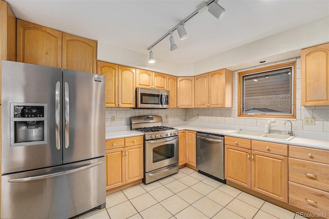 6235 W Floyd Ave, Denver, CO 80227 - kitchen with appliances with stainless steel finishes, a sink, light countertops, and decorative backsplash