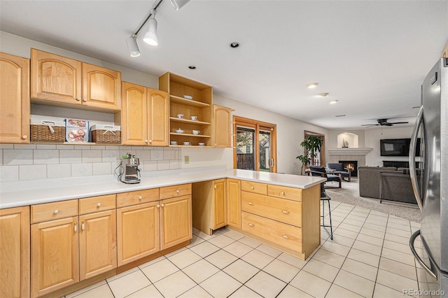 6235 W Floyd Ave, Denver, CO 80227 - kitchen featuring open shelves, a peninsula, light brown cabinets, and open floor plan