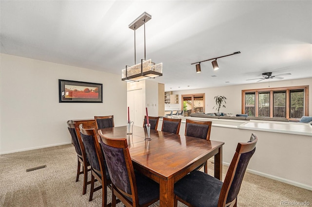 6235 W Floyd Ave, Denver, CO 80227 - dining area with light colored carpet, rail lighting, baseboards, and a ceiling fan