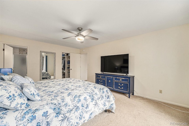 6235 W Floyd Ave, Denver, CO 80227 - bedroom featuring light carpet, a walk in closet, ceiling fan, a closet, and baseboards