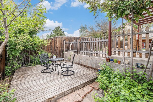 6235 W Floyd Ave, Denver, CO 80227 - wooden deck with a fenced backyard