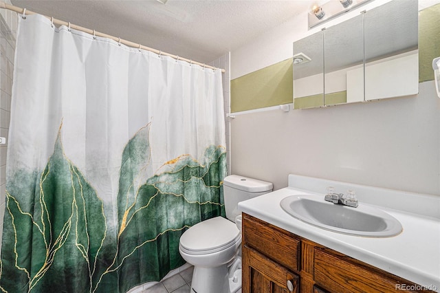 6235 W Floyd Ave, Denver, CO 80227 - bathroom featuring toilet, vanity, a textured ceiling, a shower with curtain, and tile patterned floors