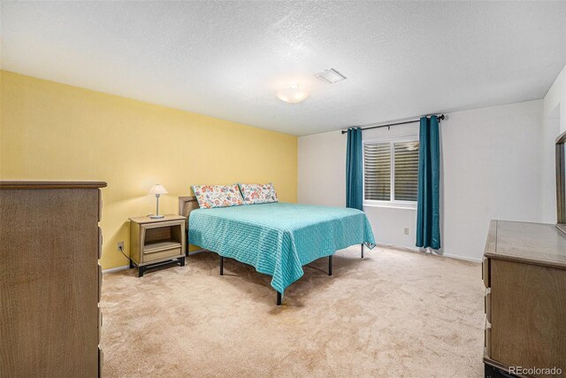6235 W Floyd Ave, Denver, CO 80227 - carpeted bedroom featuring baseboards and a textured ceiling