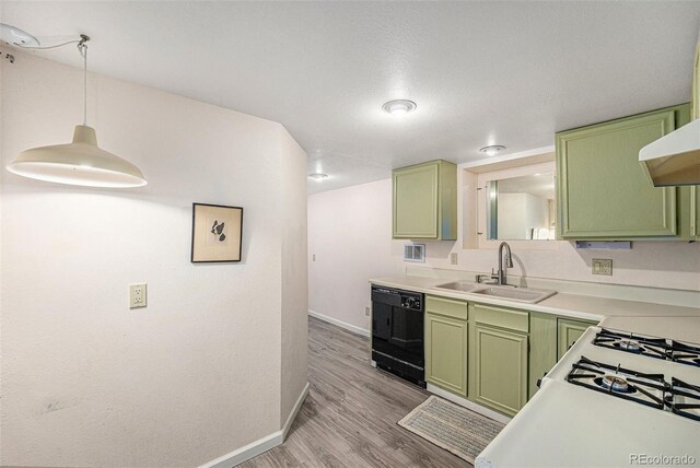 6235 W Floyd Ave, Denver, CO 80227 - kitchen with green cabinetry, dishwasher, a sink, baseboards, and light wood finished floors