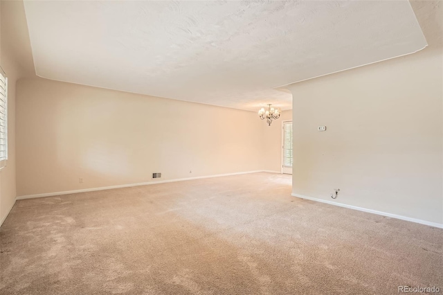 4490 Balsam St, Wheat Ridge, CO 80033 - empty room featuring a chandelier, light colored carpet, and baseboards