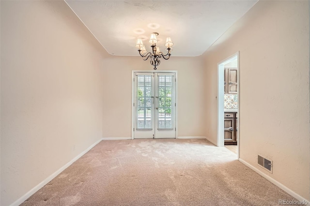 4490 Balsam St, Wheat Ridge, CO 80033 - spare room featuring a chandelier, light colored carpet, french doors, and baseboards