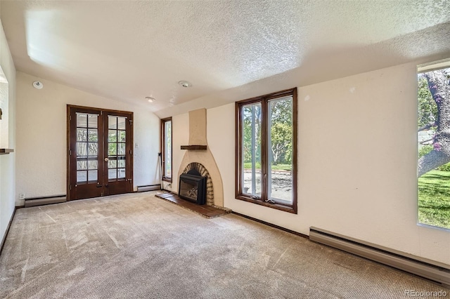 4490 Balsam St, Wheat Ridge, CO 80033 - unfurnished living room featuring french doors, a baseboard radiator, a fireplace with raised hearth, carpet flooring, and a textured ceiling