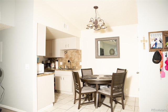 1358 S Irving St Unit A9, Denver, CO 80219 - dining room featuring a chandelier and baseboards