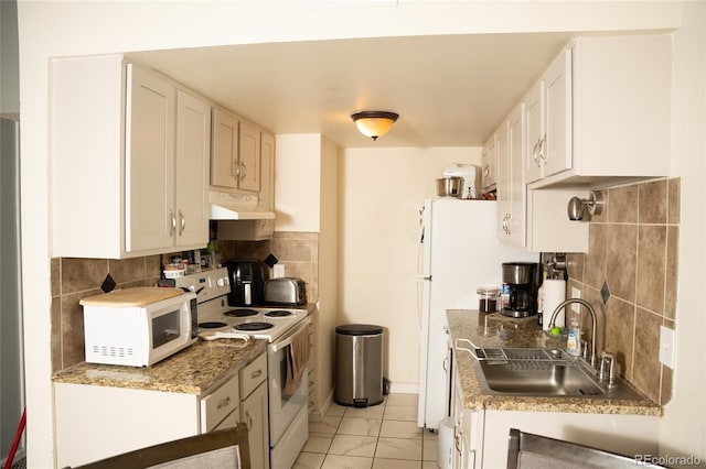 1358 S Irving St Unit A9, Denver, CO 80219 - kitchen with white appliances, under cabinet range hood, backsplash, and white cabinetry