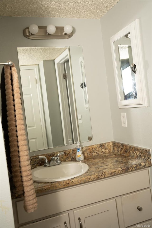 1358 S Irving St Unit A9, Denver, CO 80219 - bathroom featuring vanity and a textured ceiling