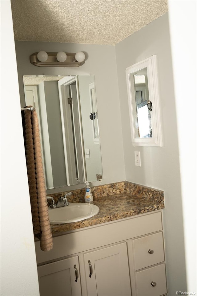 1358 S Irving St Unit A9, Denver, CO 80219 - bathroom featuring vanity and a textured ceiling