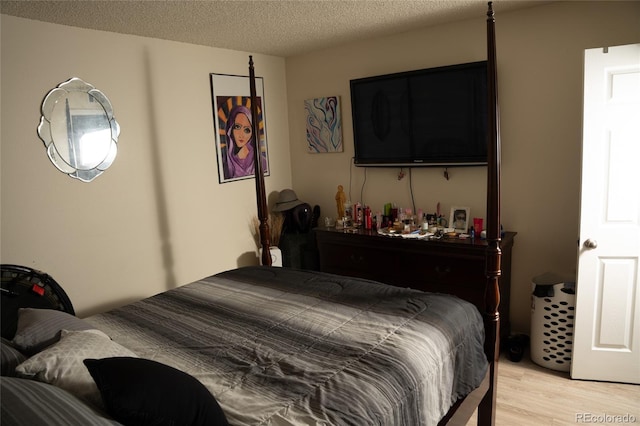 1358 S Irving St Unit A9, Denver, CO 80219 - bedroom featuring light wood-style floors and a textured ceiling