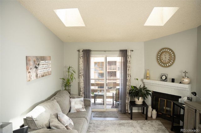 1358 S Irving St Unit A9, Denver, CO 80219 - living area featuring a skylight, a fireplace, wood finished floors, and lofted ceiling