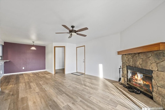 living room with ceiling fan, hardwood / wood-style floors, and a fireplace