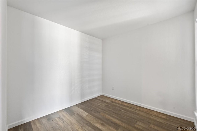 spare room featuring dark hardwood / wood-style flooring