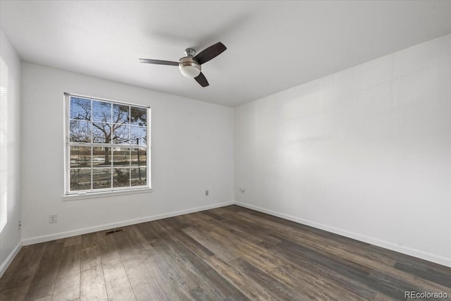 empty room featuring ceiling fan and dark hardwood / wood-style flooring